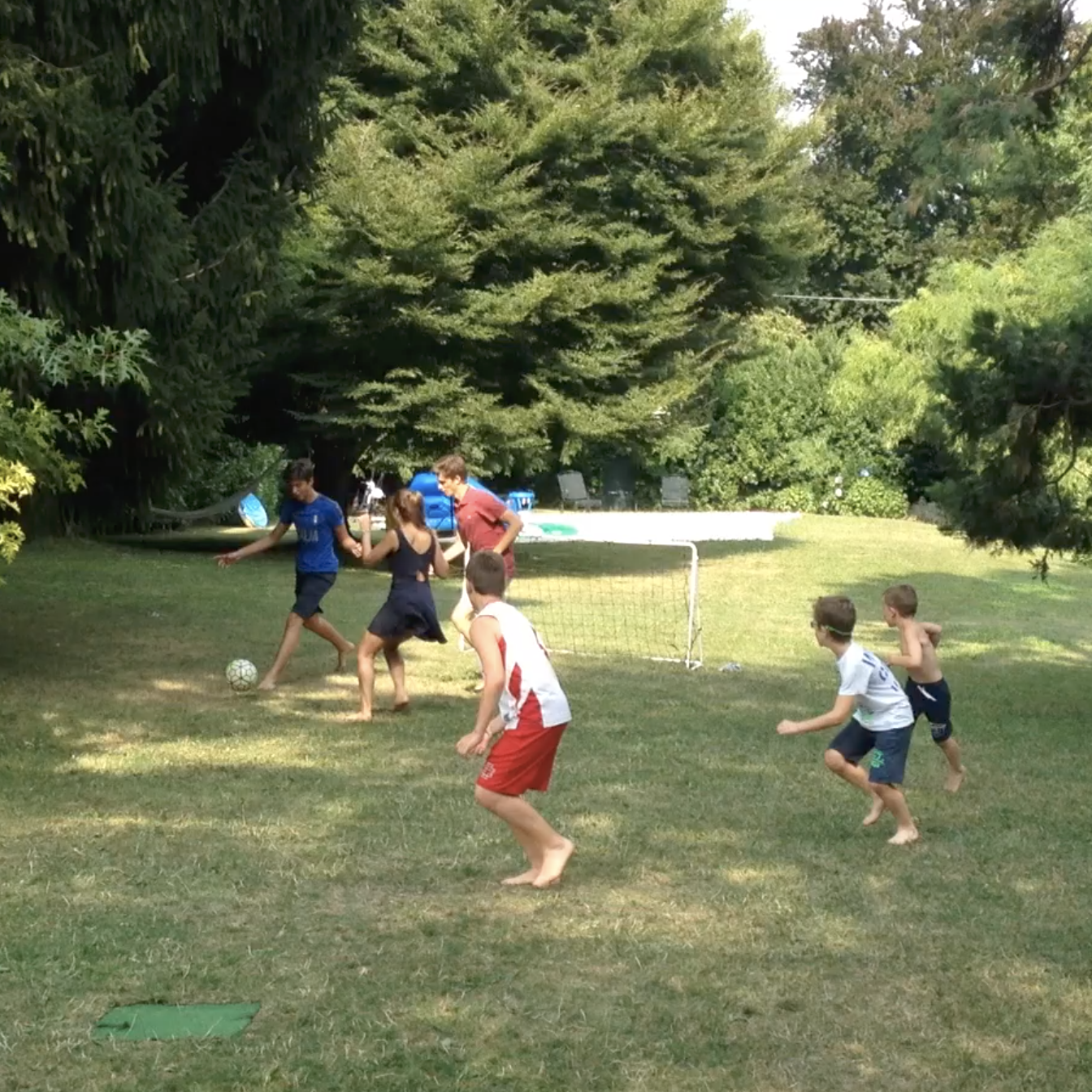 A family soccer game on the lawn
